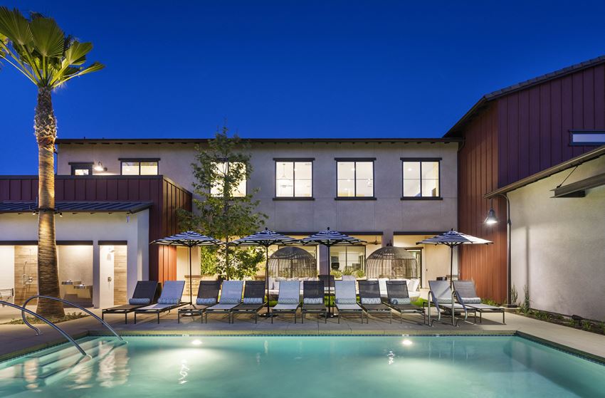 Apartments in Montclair CA - Expansive Swimming Pool Surrounded by Various Lounge Chairs - Photo Gallery 1