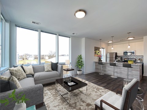 a living room with a couch and a coffee table and a kitchen