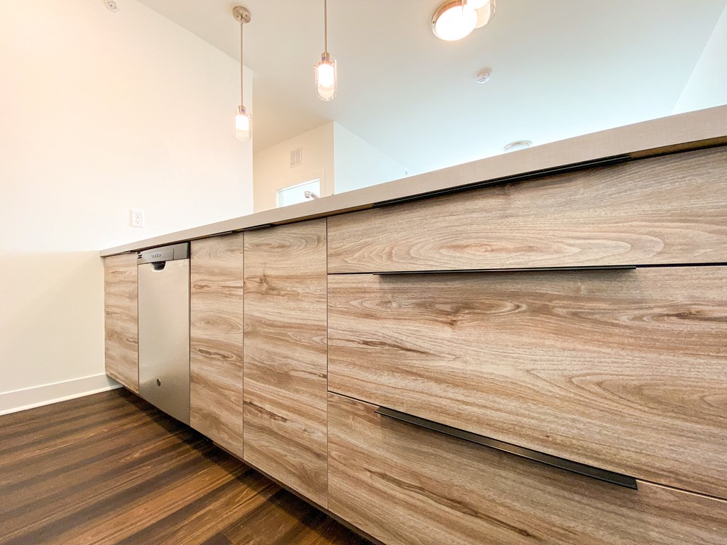 a kitchen with wooden cabinets and a long counter top