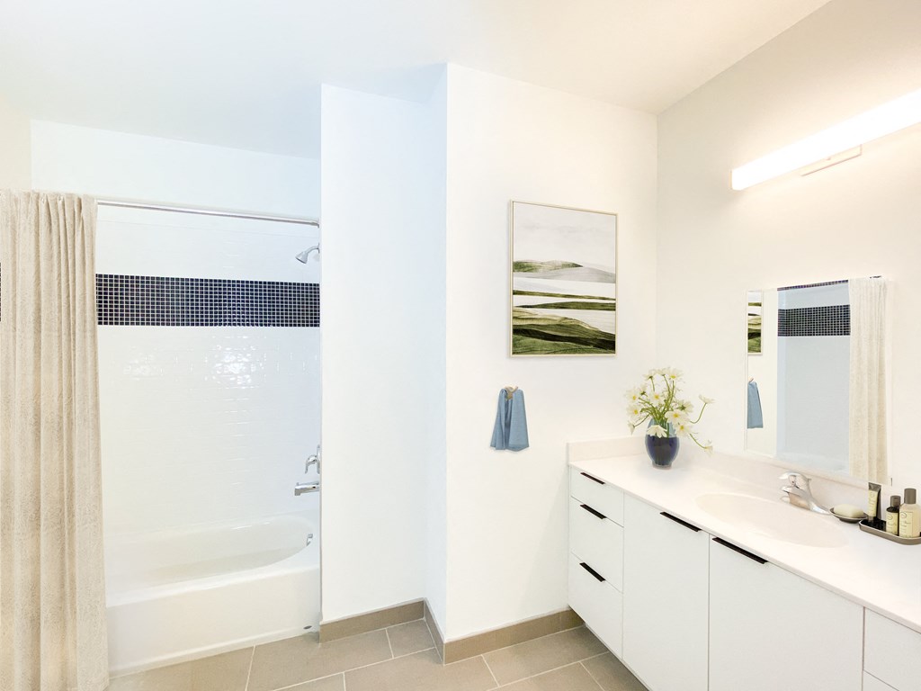 a bathroom with a shower and a sink and a mirror