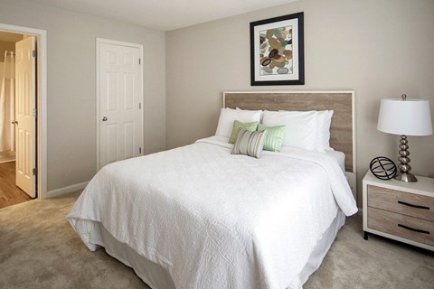 a bedroom with a white bed and a lamp