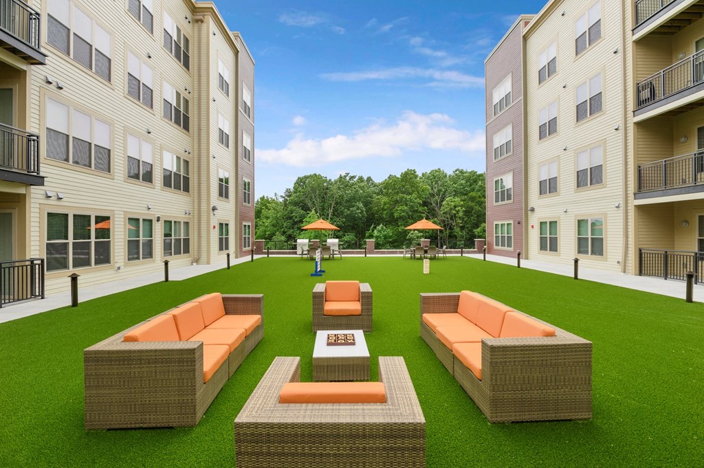 a rendering of an outdoor lounge area in an apartment building