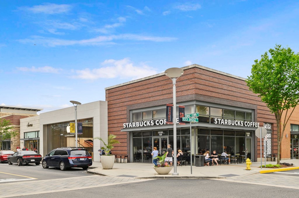 a starbucks coffee shop on the corner of a city street