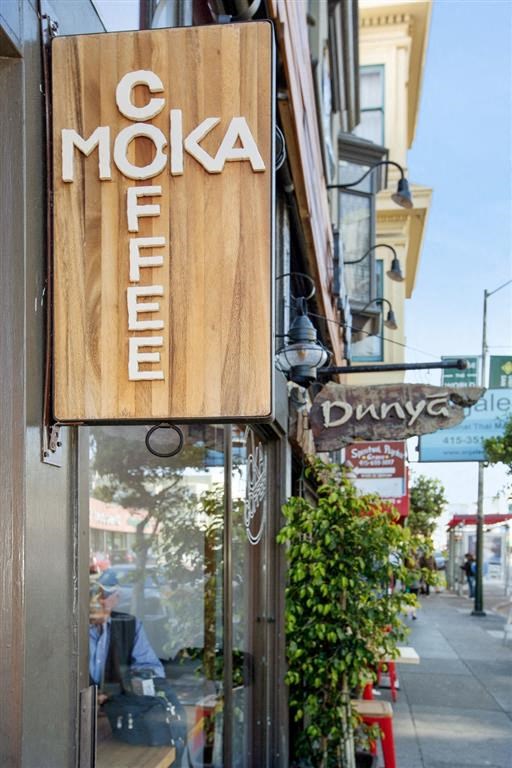 a sign for the moka diner on the side of a building