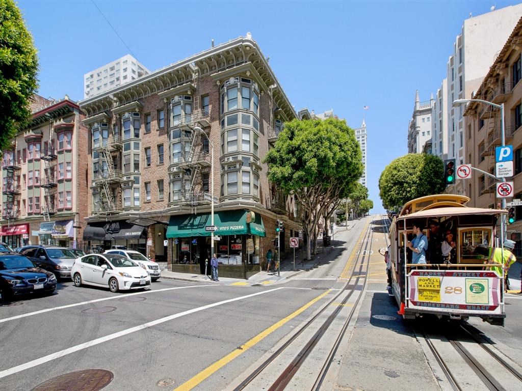 a trolley on a city street in front of a building