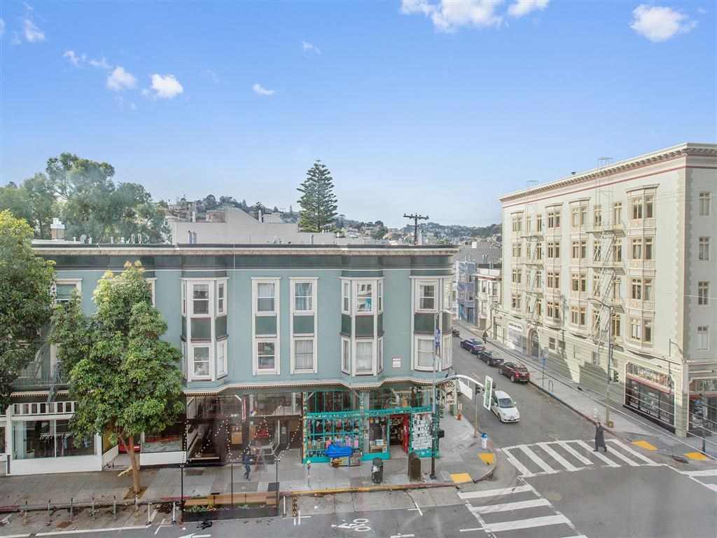 an aerial view of a blue and white building on a city street