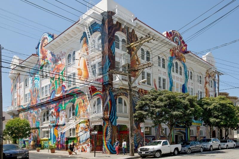 a building with graffiti on it on a city street