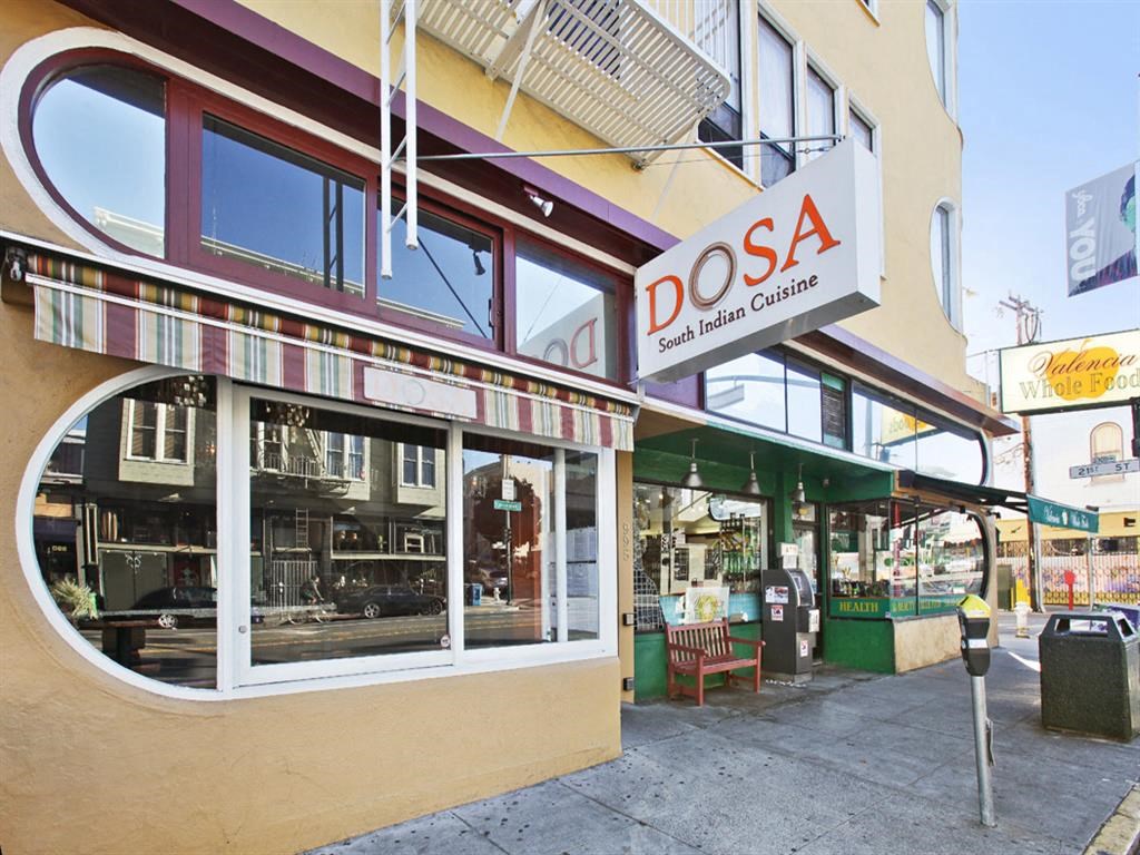 the front of a store with a sign in the window