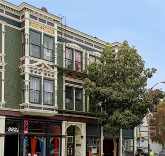 a building on a city street with a tree