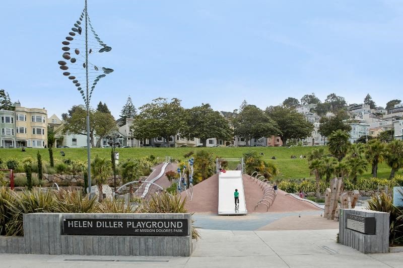 a park with a fountain and a sign