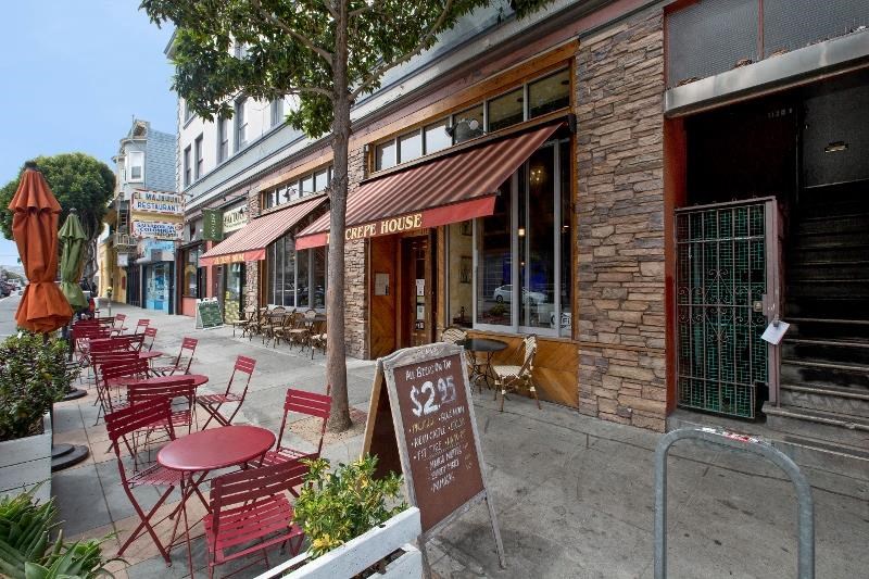 a group of tables and chairs outside of a restaurant