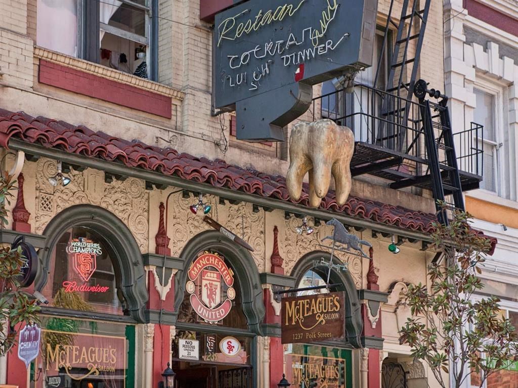a statue of a pig on the top of a building