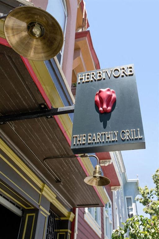 a sign for the earthy grill on the side of a building