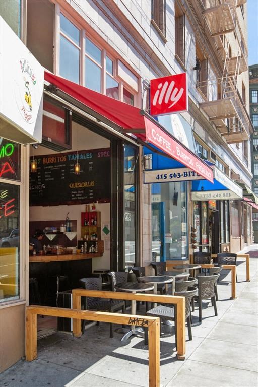 a row of tables and chairs outside of a restaurant