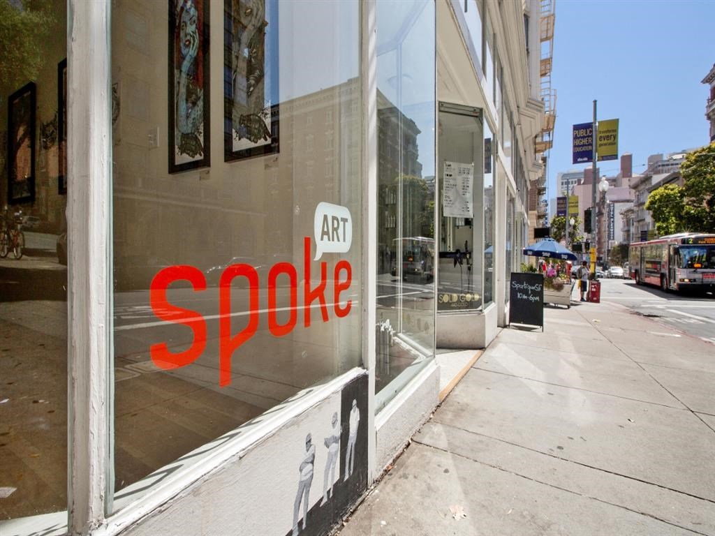 a sign in the window of a store on a city street