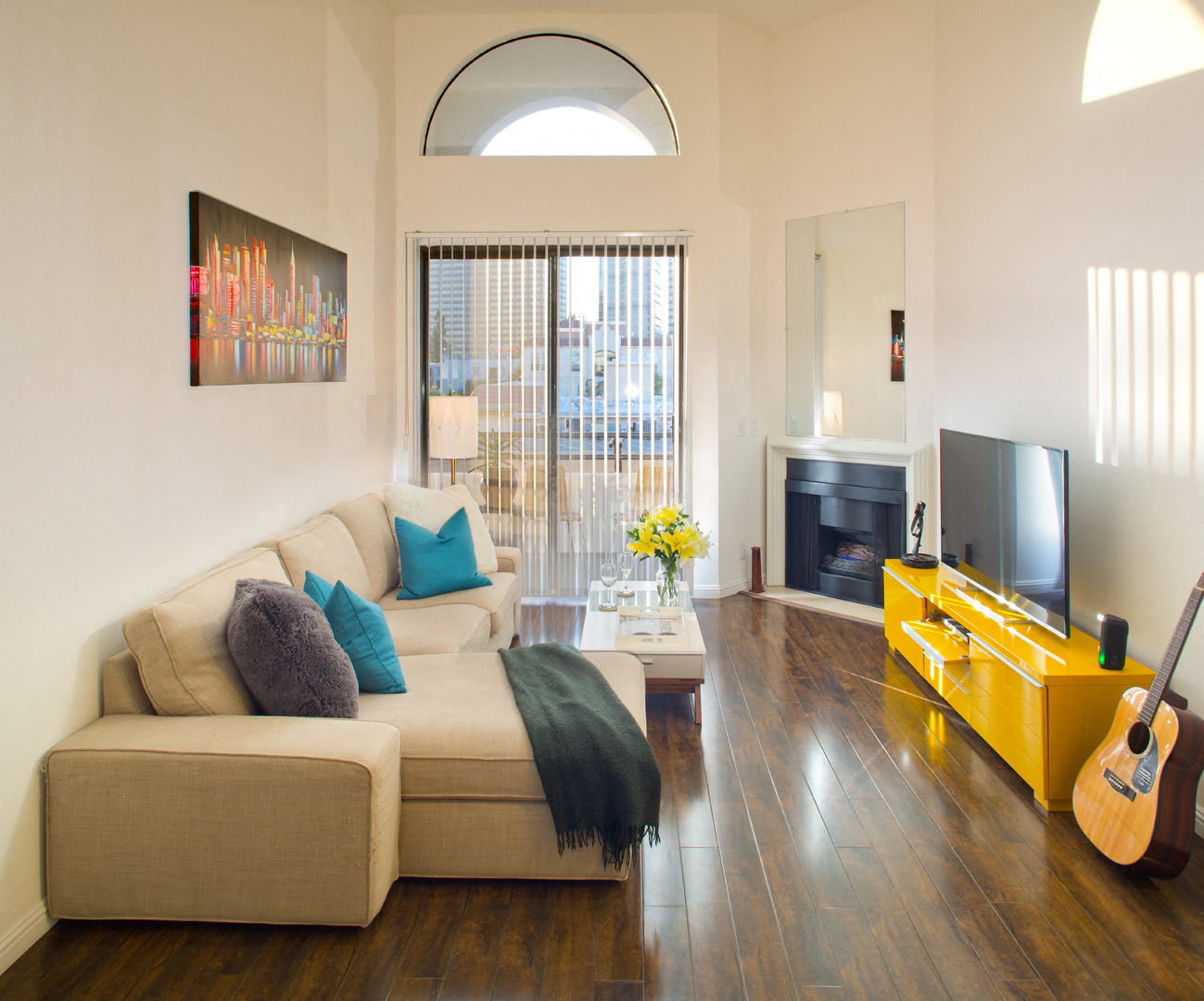a living room with a couch and a yellow entertainment center