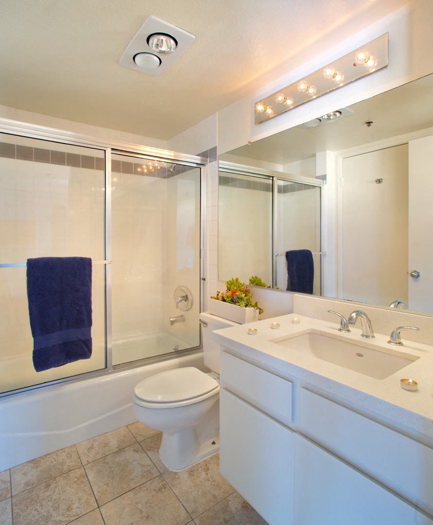 a bathroom with a toilet and a sink and a shower