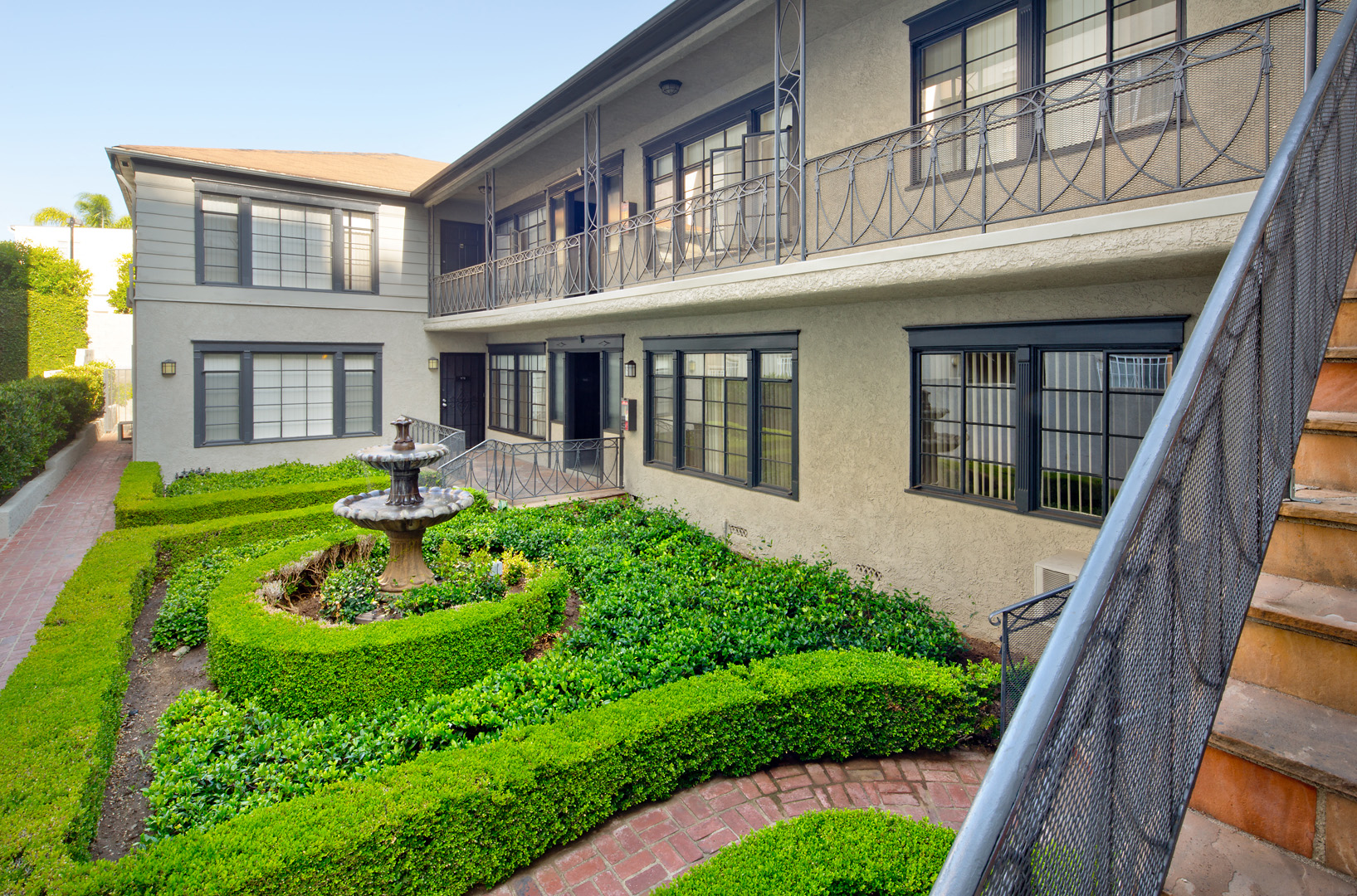 a courtyard with a fountain in front of a building