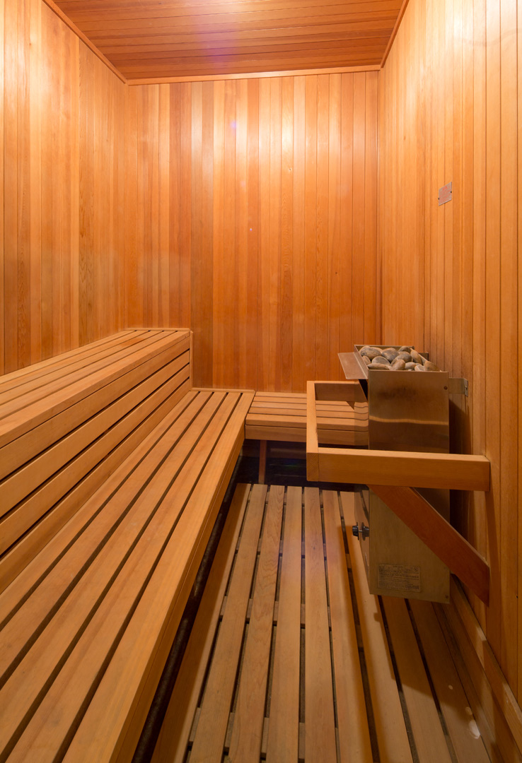 a wooden sauna with a bench and a table