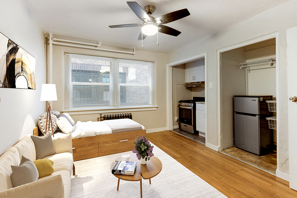 a living room with a couch and a ceiling fan