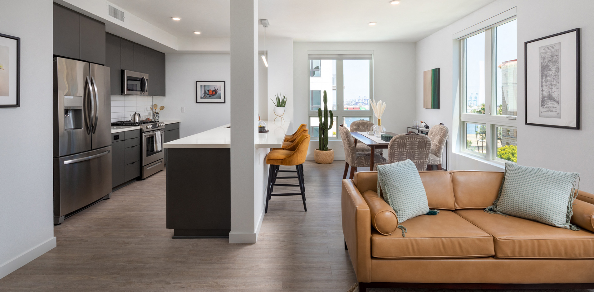 a living room and kitchen with a couch and a table