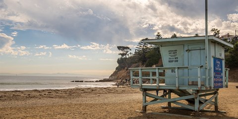 a lifeguard tower on the beach on a cloudy day