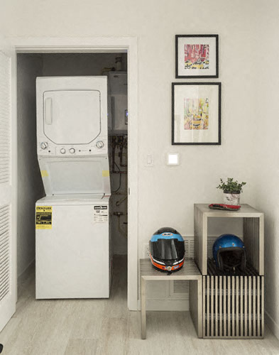 a room with a washing machine and a refrigerator     and a helmet