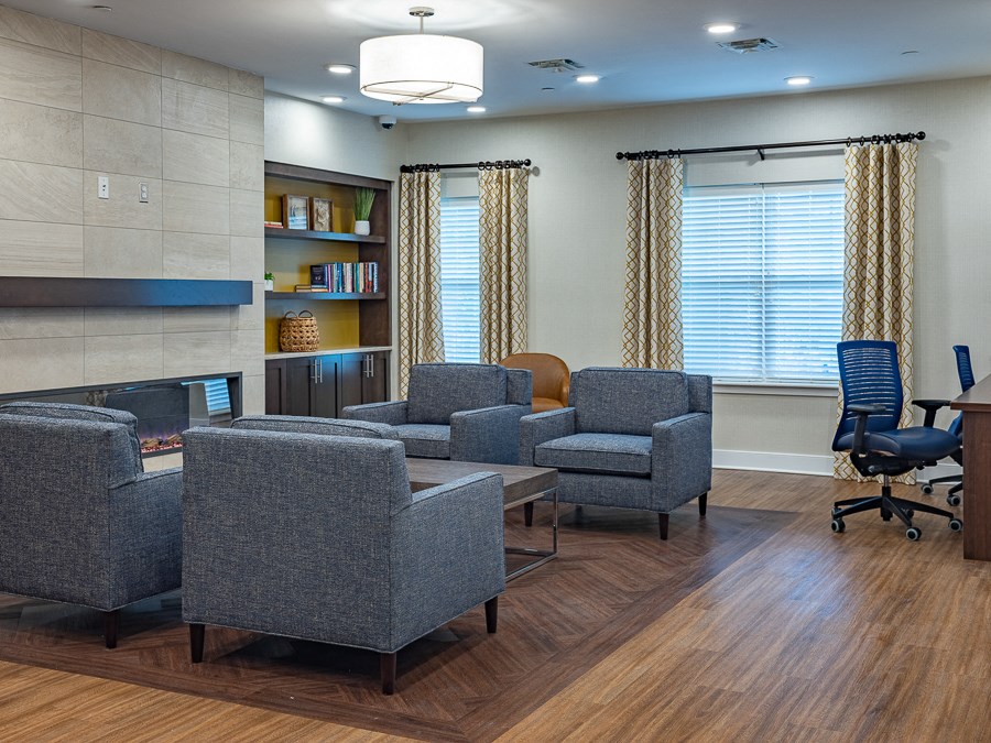 a waiting room with chairs and a fire place