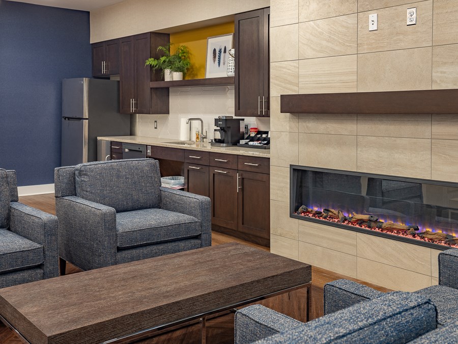 a living room with a fireplace and a table with chairs