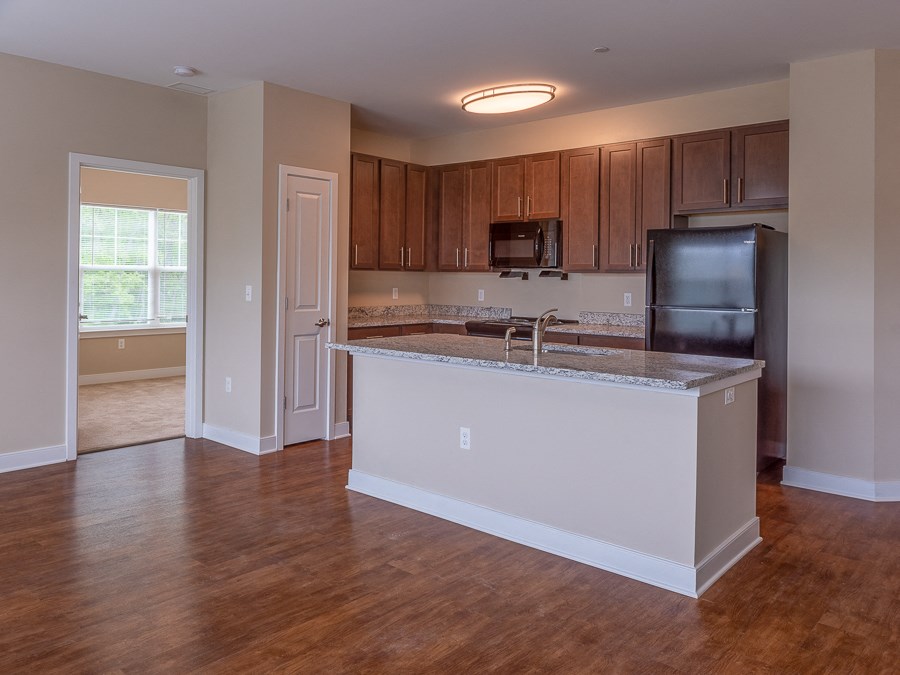 an empty kitchen with an island in the middle