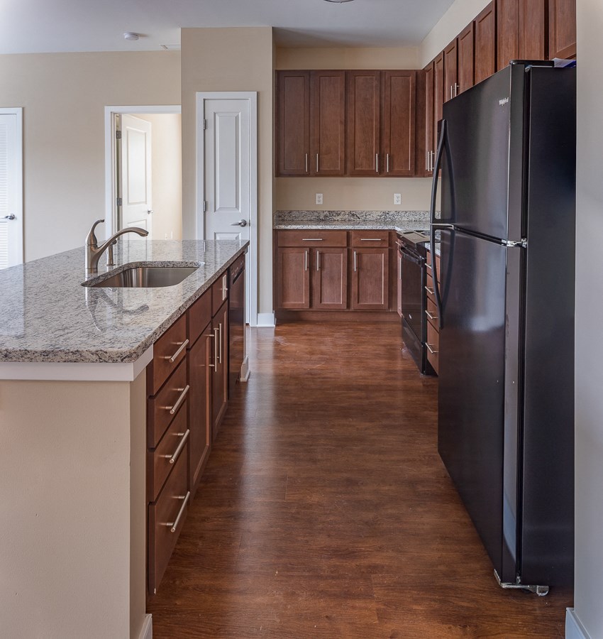 a kitchen with black appliances and granite counter tops