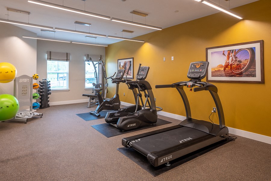 a gym with treadmills and other exercise equipment at the community center