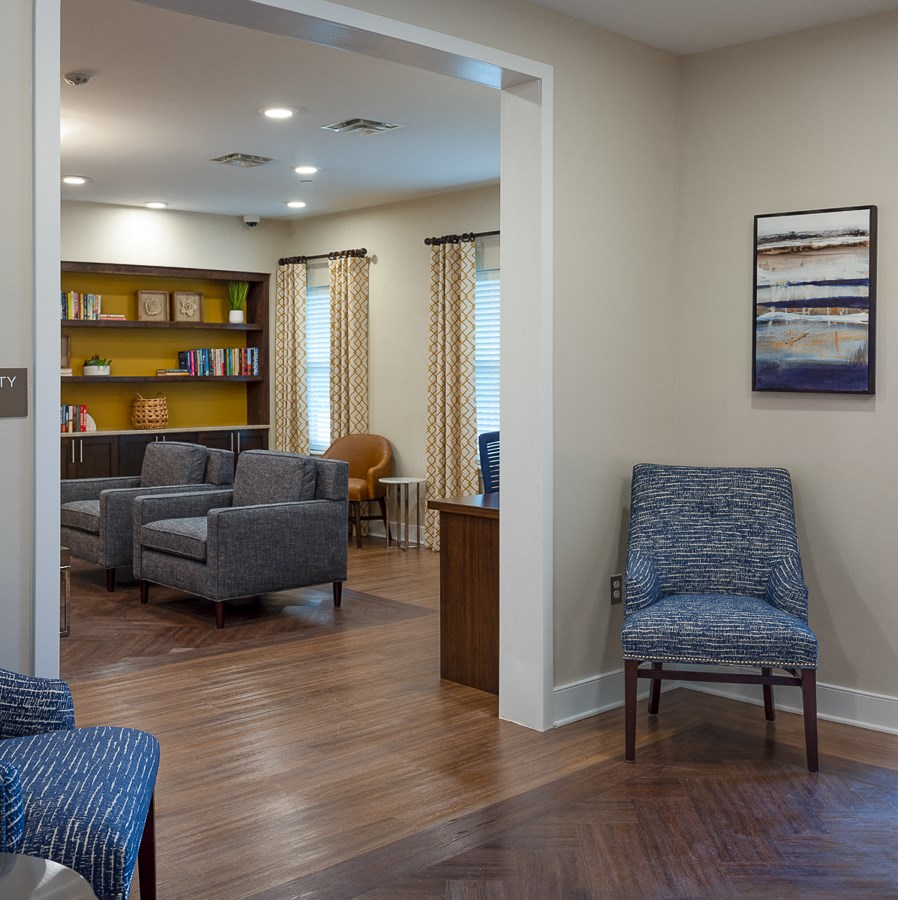 a living room with chairs and a table