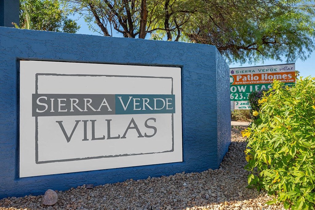 a sign villas at the entrance to the village