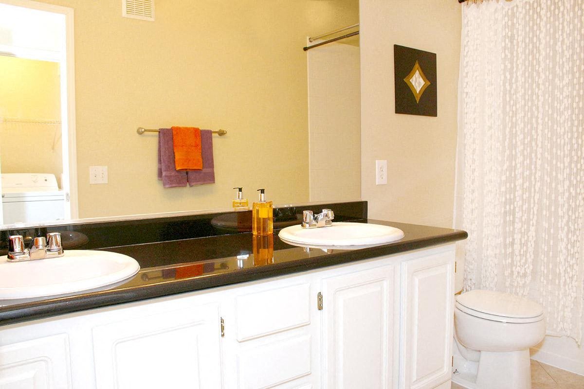 a bathroom with two sinks and a toilet