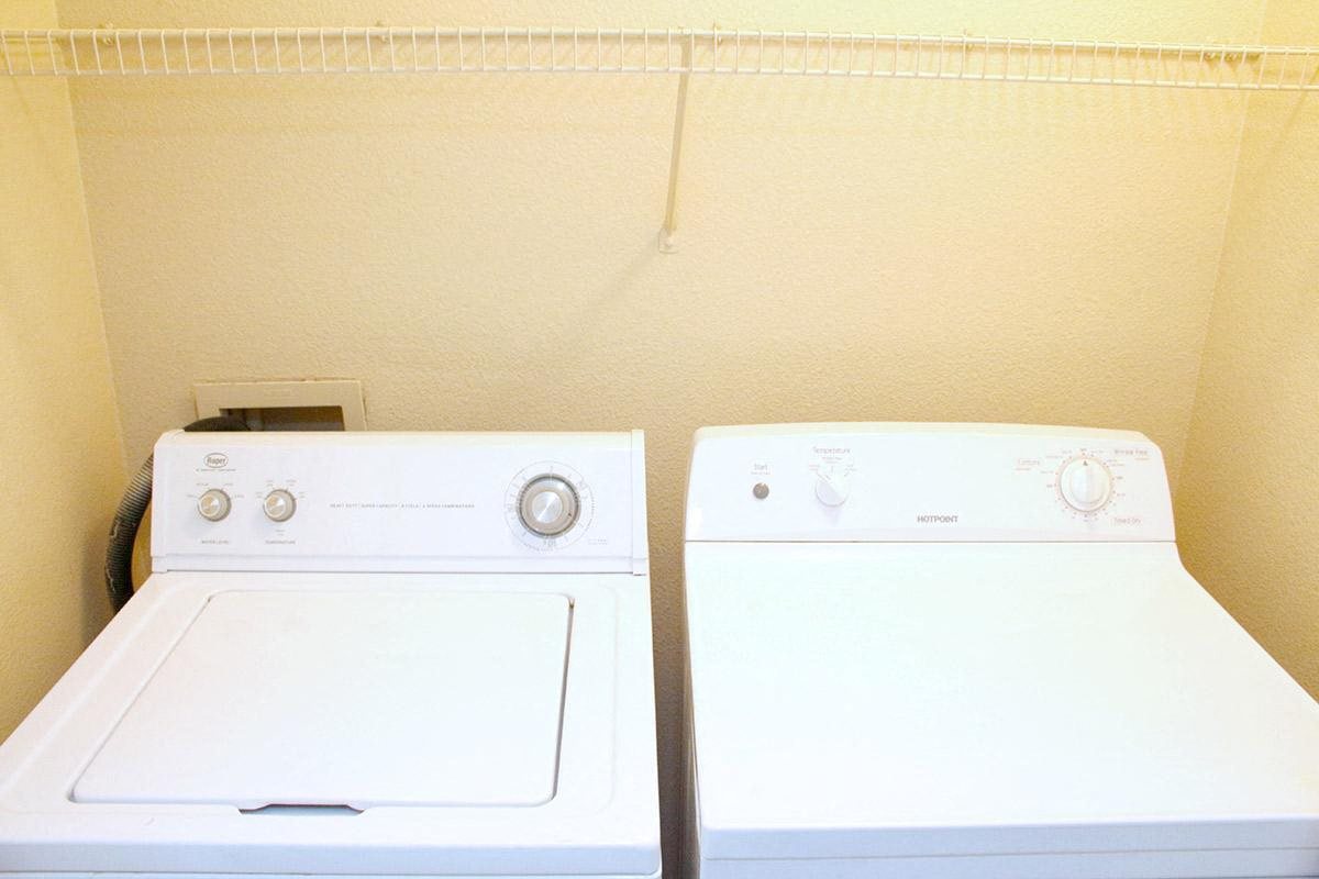 two white washers and dryers next to each other