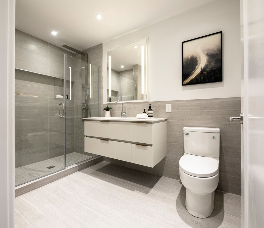 a bathroom with a toilet and a shower