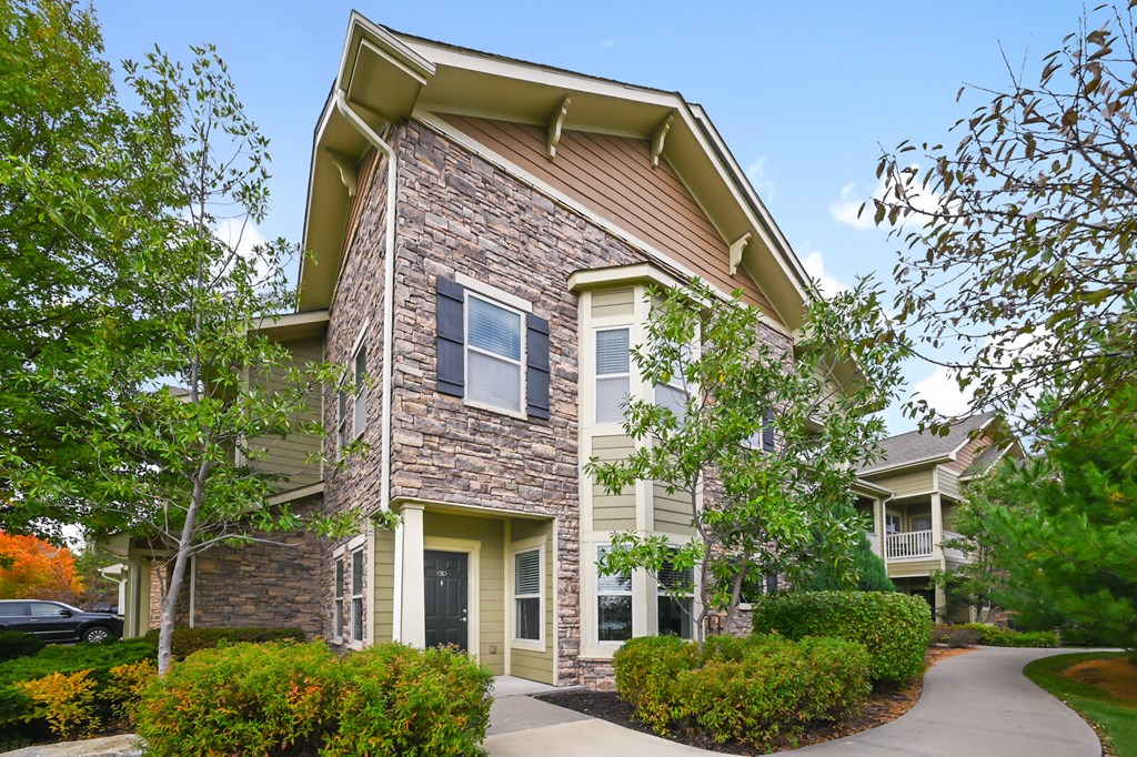 an apartment building with a sidewalk in front of it