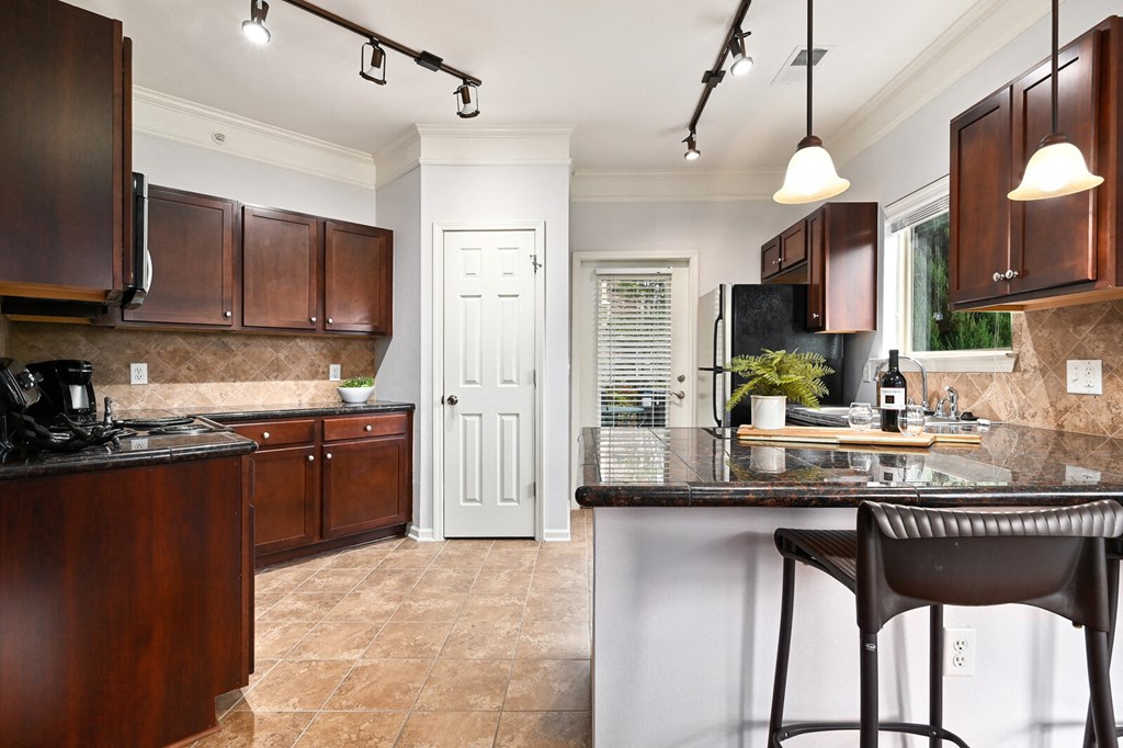 a kitchen with brown cabinets and a counter top