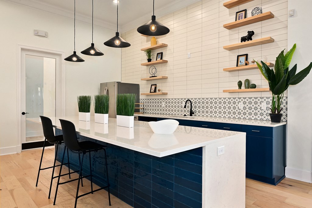 a kitchen with a large white counter top and blue cabinets