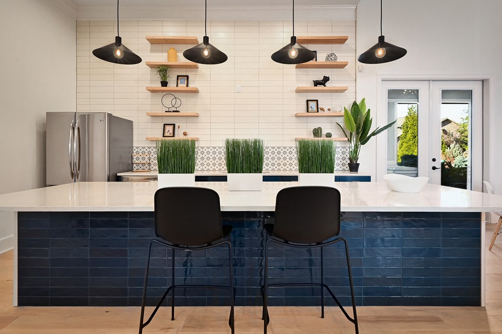 a kitchen with a white counter top and blue tiles