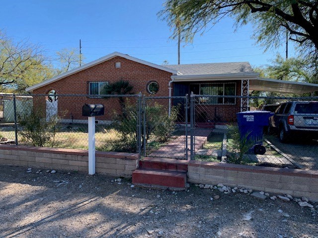 a house with a fence in front of it