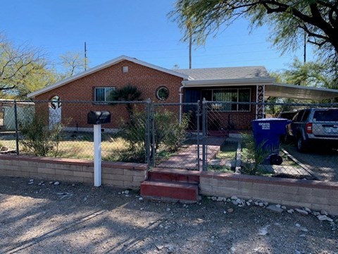 a house with a fence in front of it