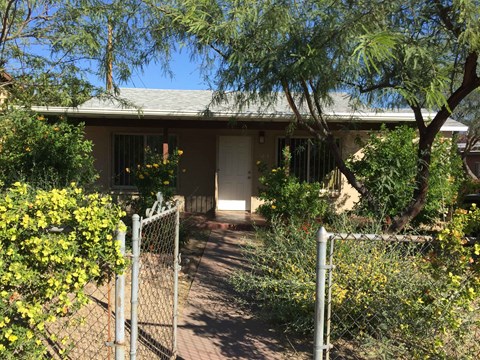 a house with a pathway and a fence in front of it