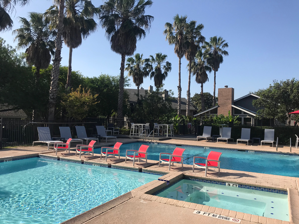 orange lounge chairs lined up by the pool