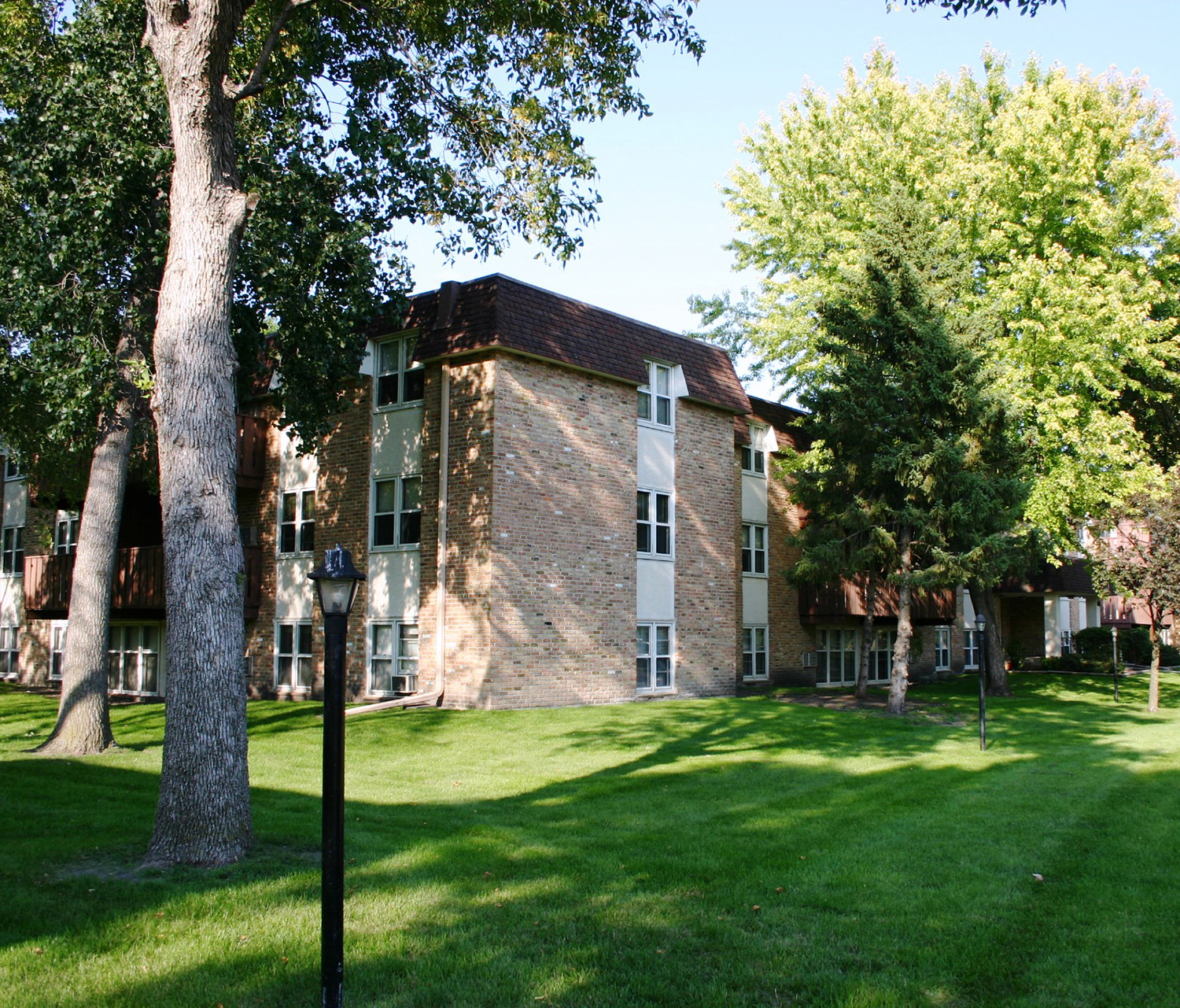 a large brick building with trees in front of it