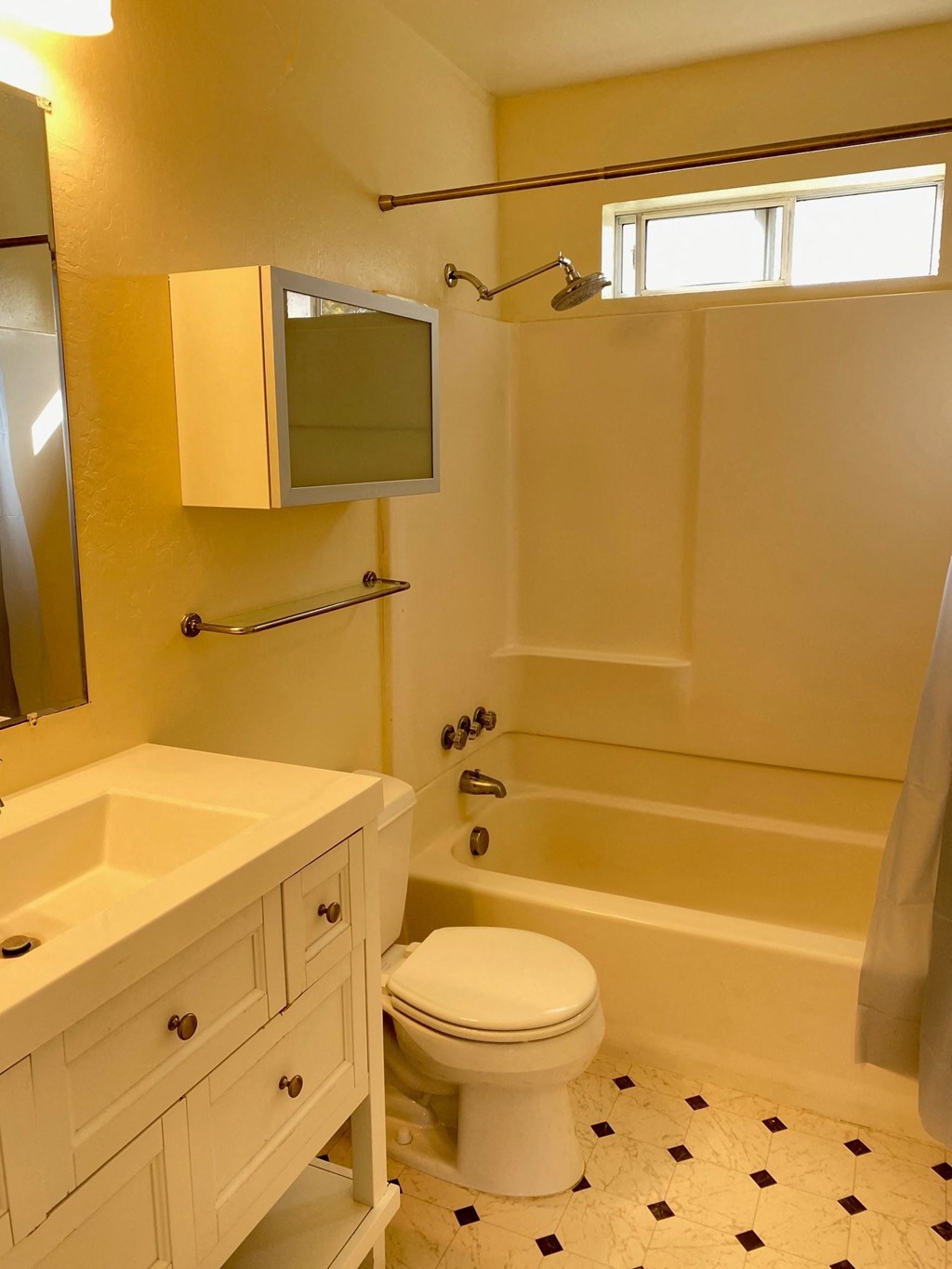 a bathroom with a toilet and a tub and a sink