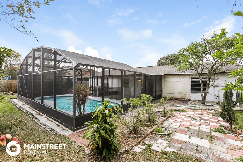 a home with a pool and a glass house