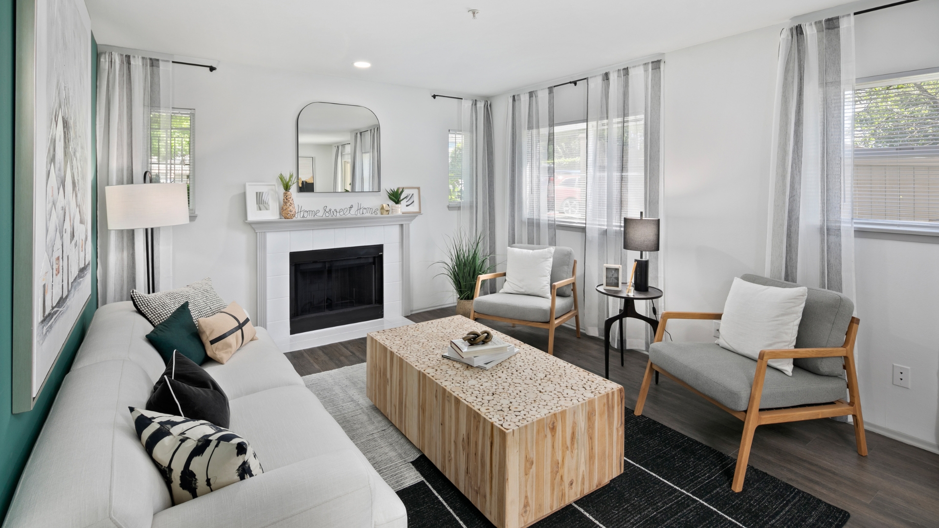 A living room with a fireplace, two chairs, and a coffee table.