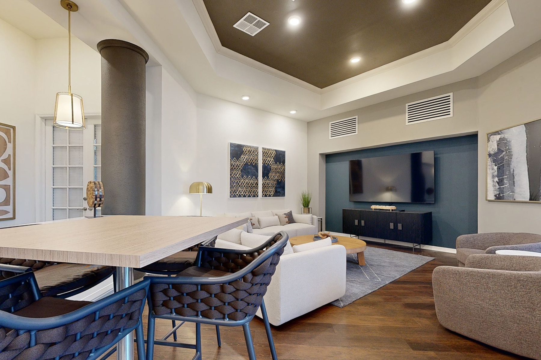 A modern living room with a large table and chairs.